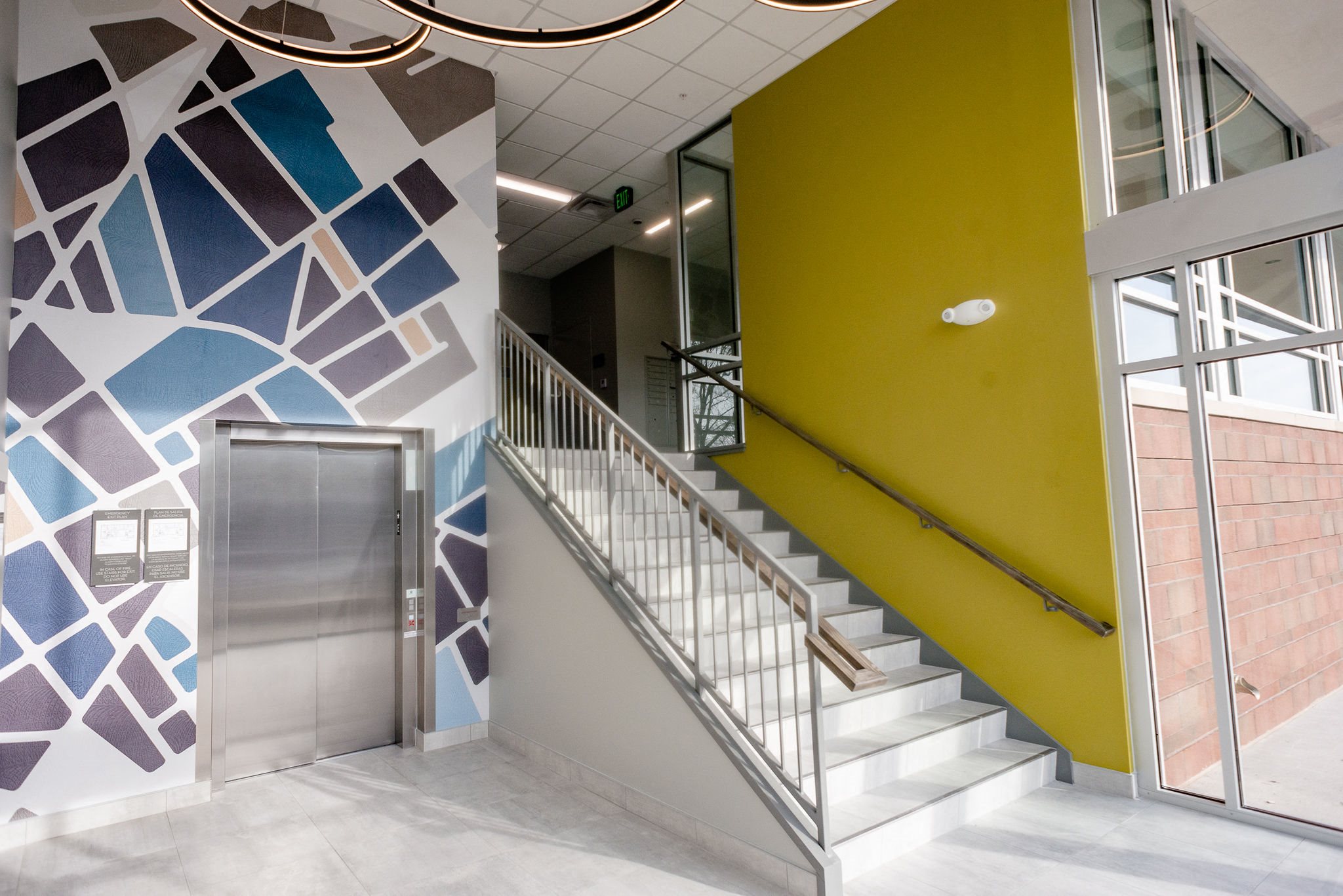 apartment entrance with yellow wall and mural